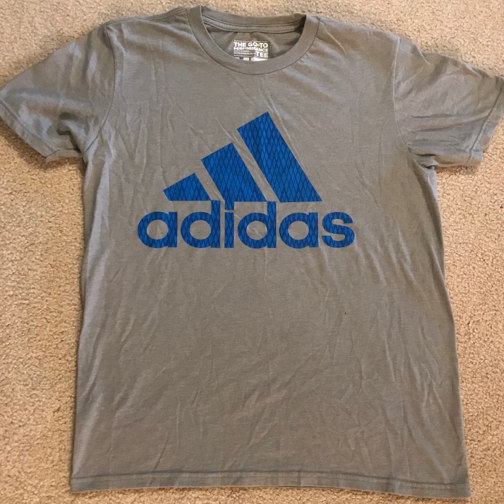 Light grey Adidas shirt with blue logo.